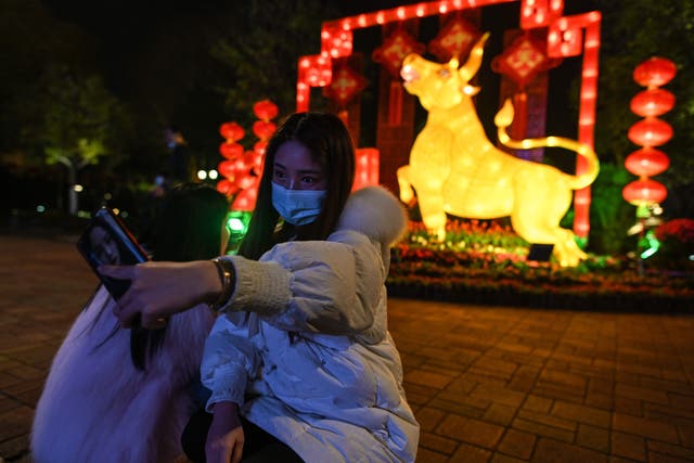 A young woman takes a selfie in Wuhan ahead of the Lunar New Year, which ushers in the Year of the Ox on Thursday