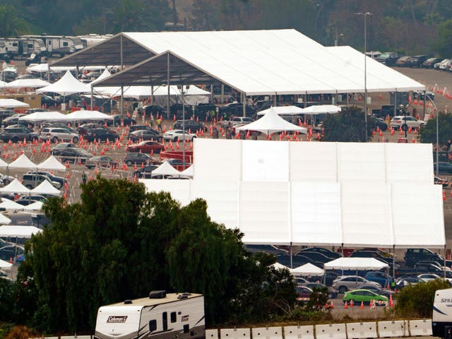 <p>Motorists receive Covid-19 vaccines under large tents at a Los Angeles County location at Dodger Stadium in Los Angeles, Wednesday 10 February 2021</p>