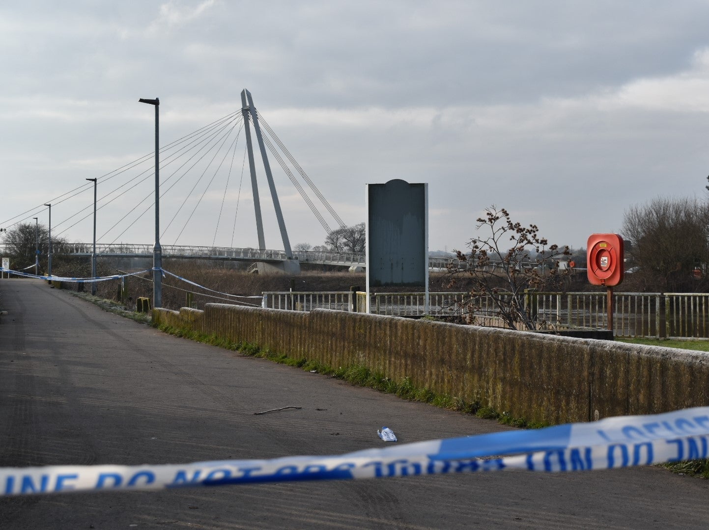 A police cordon near the Diglis footbridge in Worcester, where specialist teams are searching a stretch of the River Severn after a man was arrested on suspicion of murder