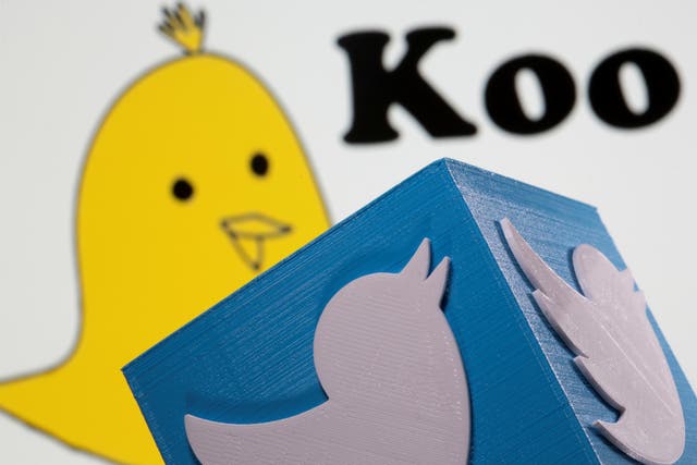 <p>A 3d printed Twitter logo is seen in front of the Koo app's logo</p>