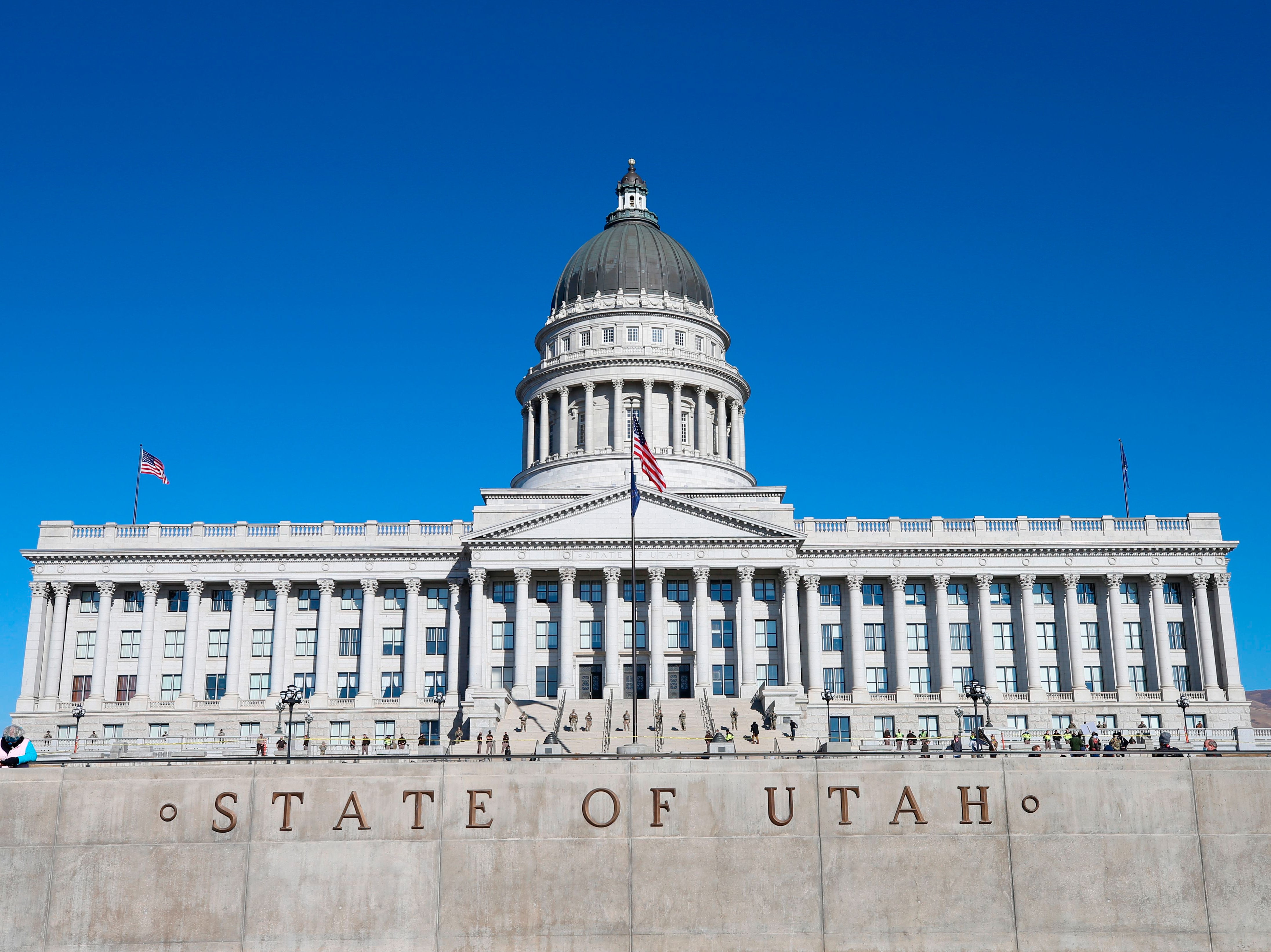 Utah National Guard troops and Utah Highway Patrol officers stand guard at the Utah State Capitol building in Salt Lake City, Utah on January 17, 2021.