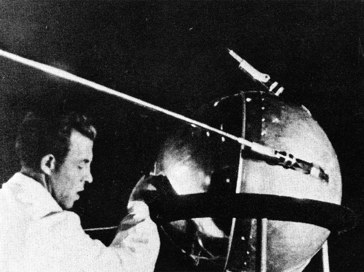 A technician putting the finishing touches on Sputnik 1, humanity’s first artificial satellite