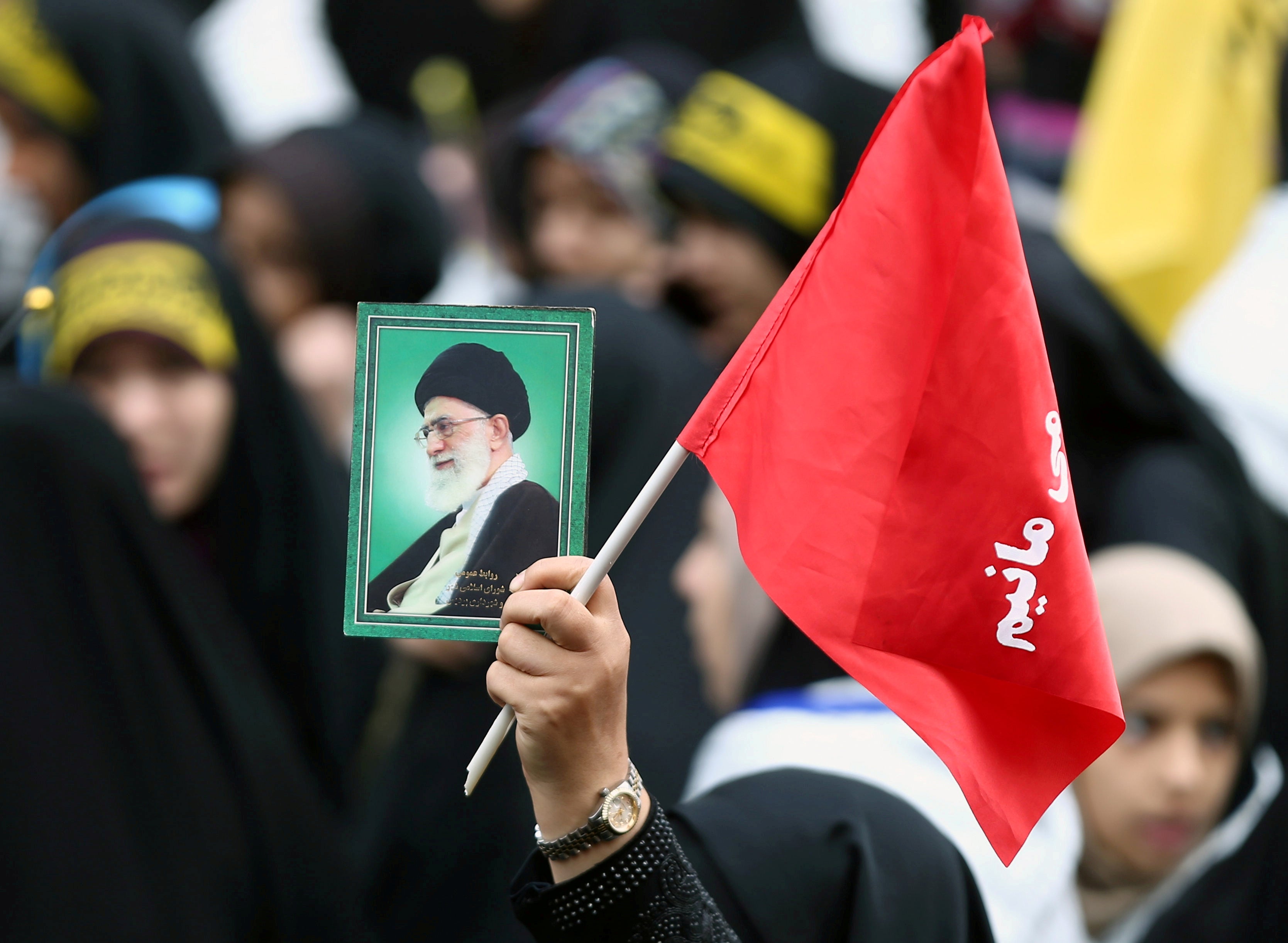 An Iranian protester holds the picture of Iranian Supreme Leader Ayatollah Ali Khamenei as she attends an anti US demonstration, marking the 40th anniversary of the US embassy takeover