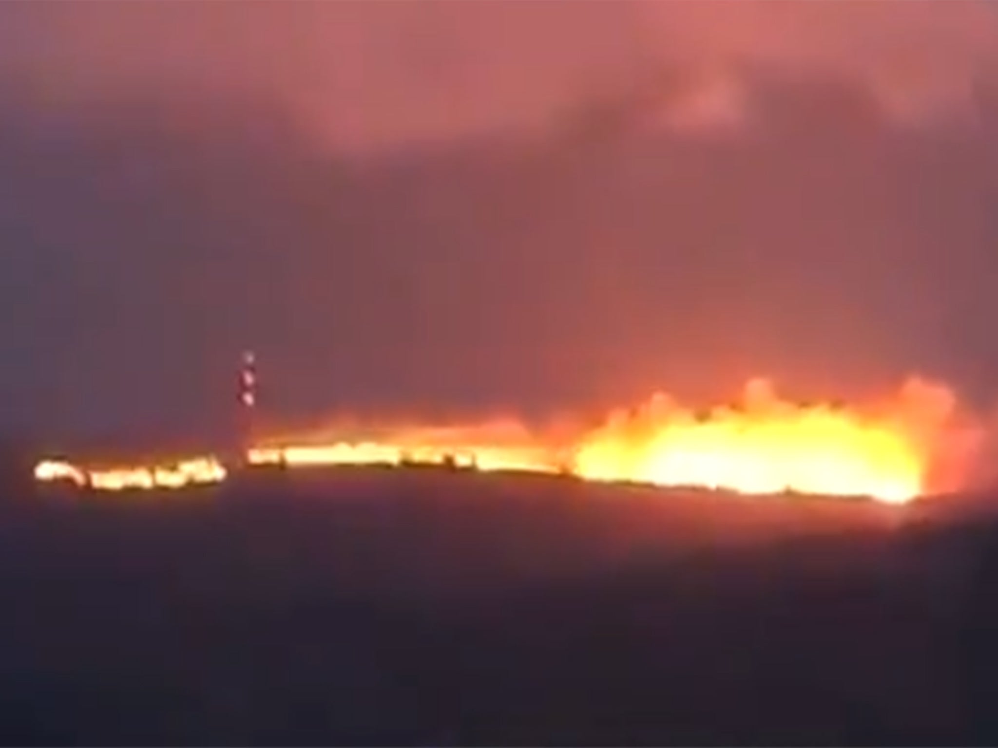 Flames light up the sky in this still image taken from a video