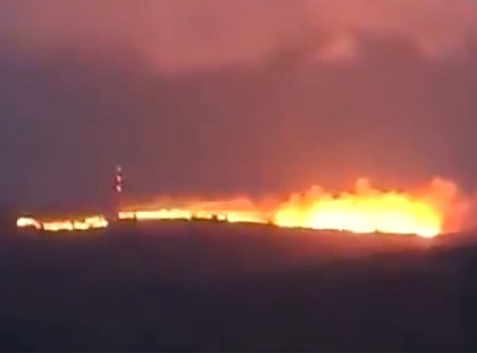 <p>Flames light up the sky in this still image taken from a video</p>