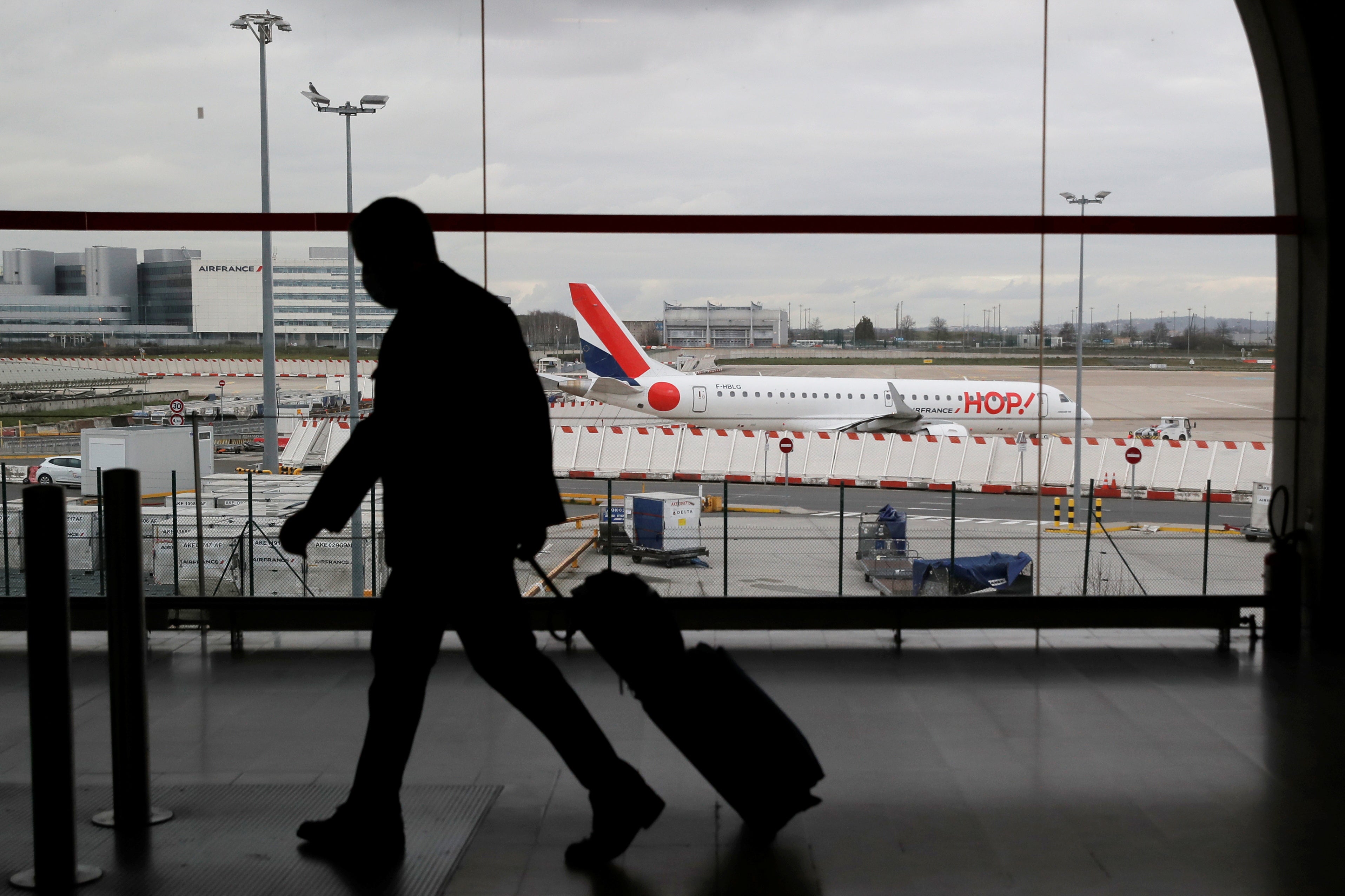 <p>A man walks inside a terminal at Paris Charles de Gaulle Airport</p>
