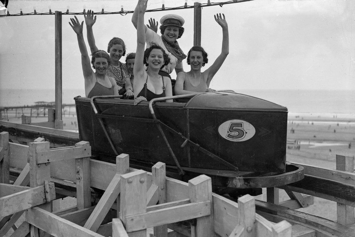 June 1936: Holidaymakers on a fairground ride at Butlin’s in Skegness