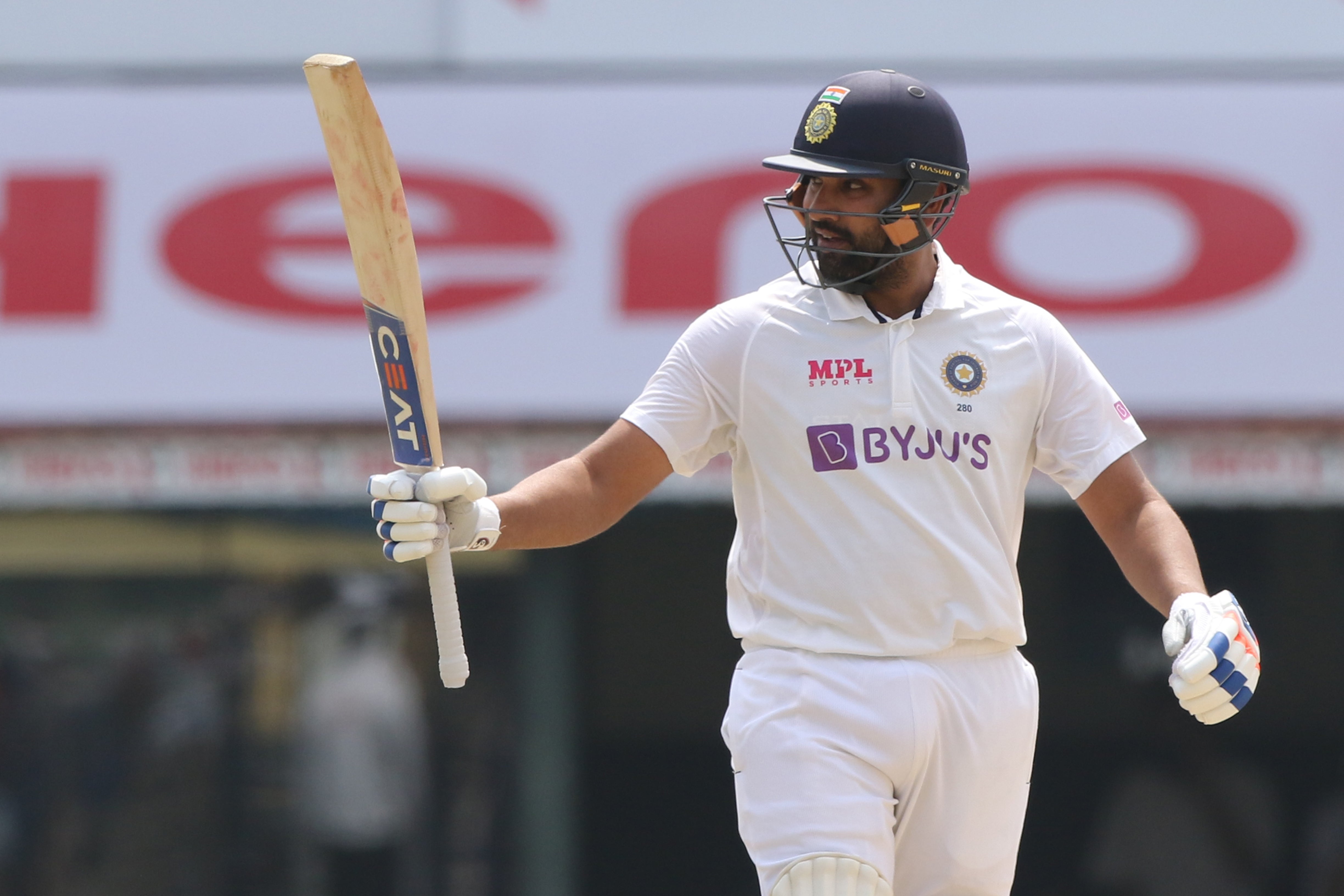 Rohit Sharma of India celebrates after scoring a hundred during day one