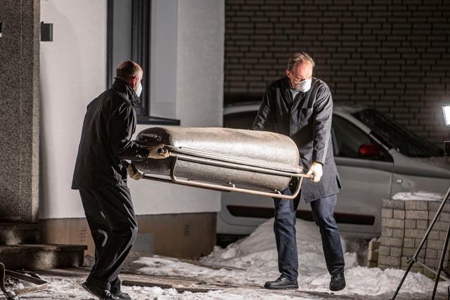 <p>A coffin is carried out of a house in Radevormwald, western Germany, after the fire</p>