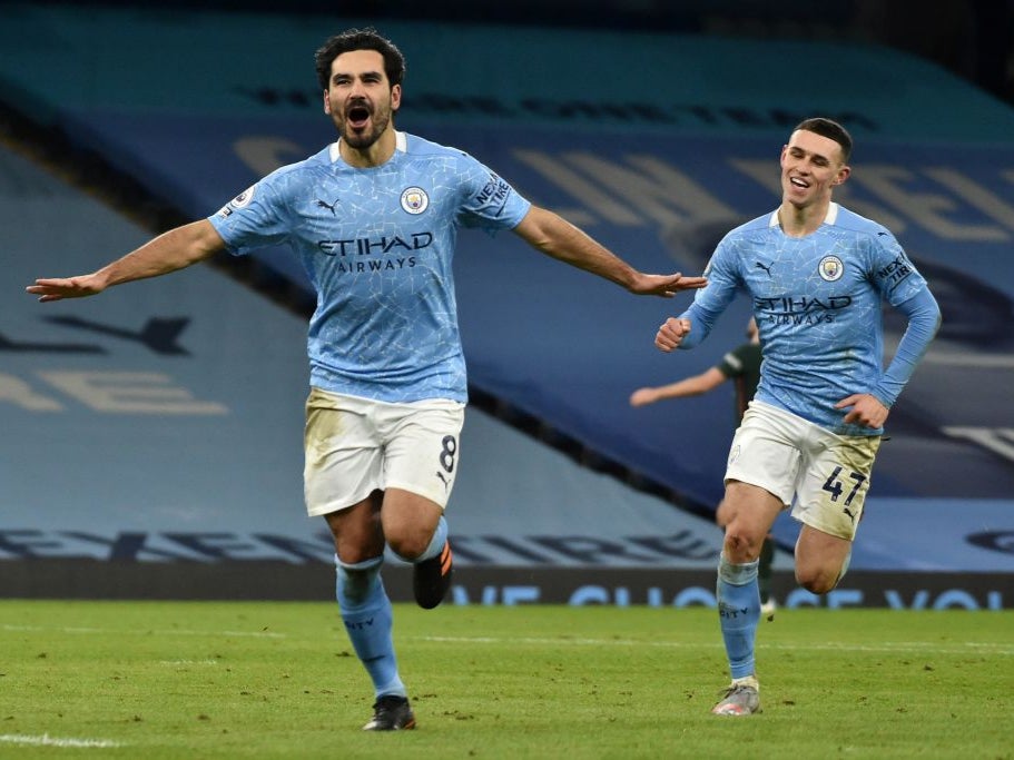 Ilkay Gundogan celebrates scoring with Phil Foden