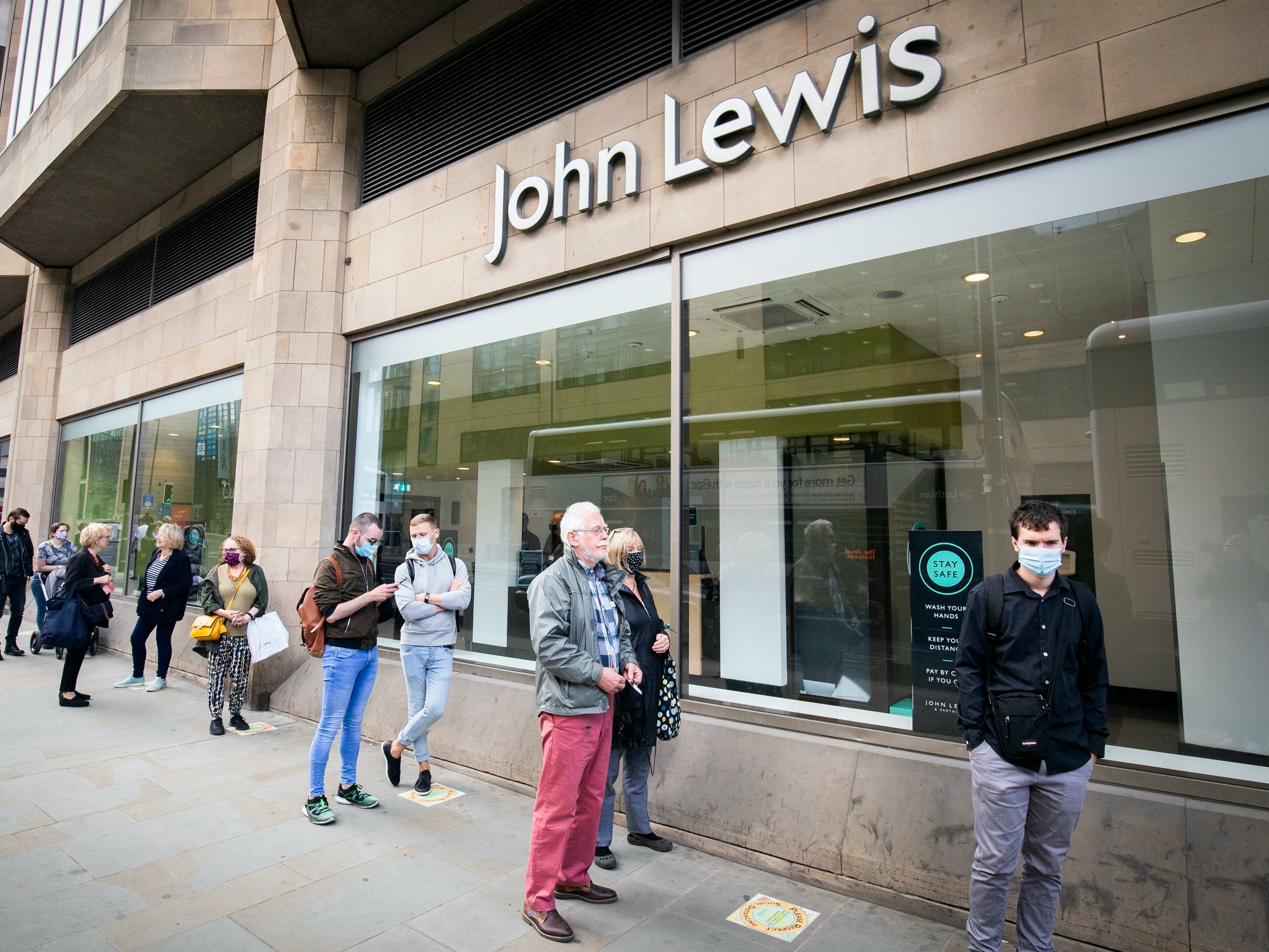 People queue outside a John Lewis store in Edinburgh in July 2020 as the first lockdown was eased