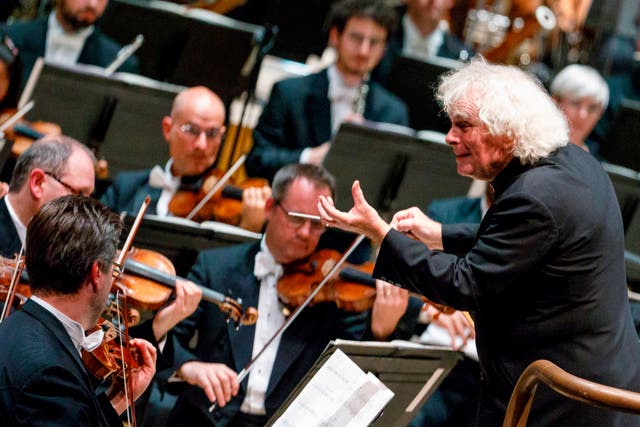 <p>Simon Rattle conducting his first concert as head of the LSO at the Barbican in 2017</p>