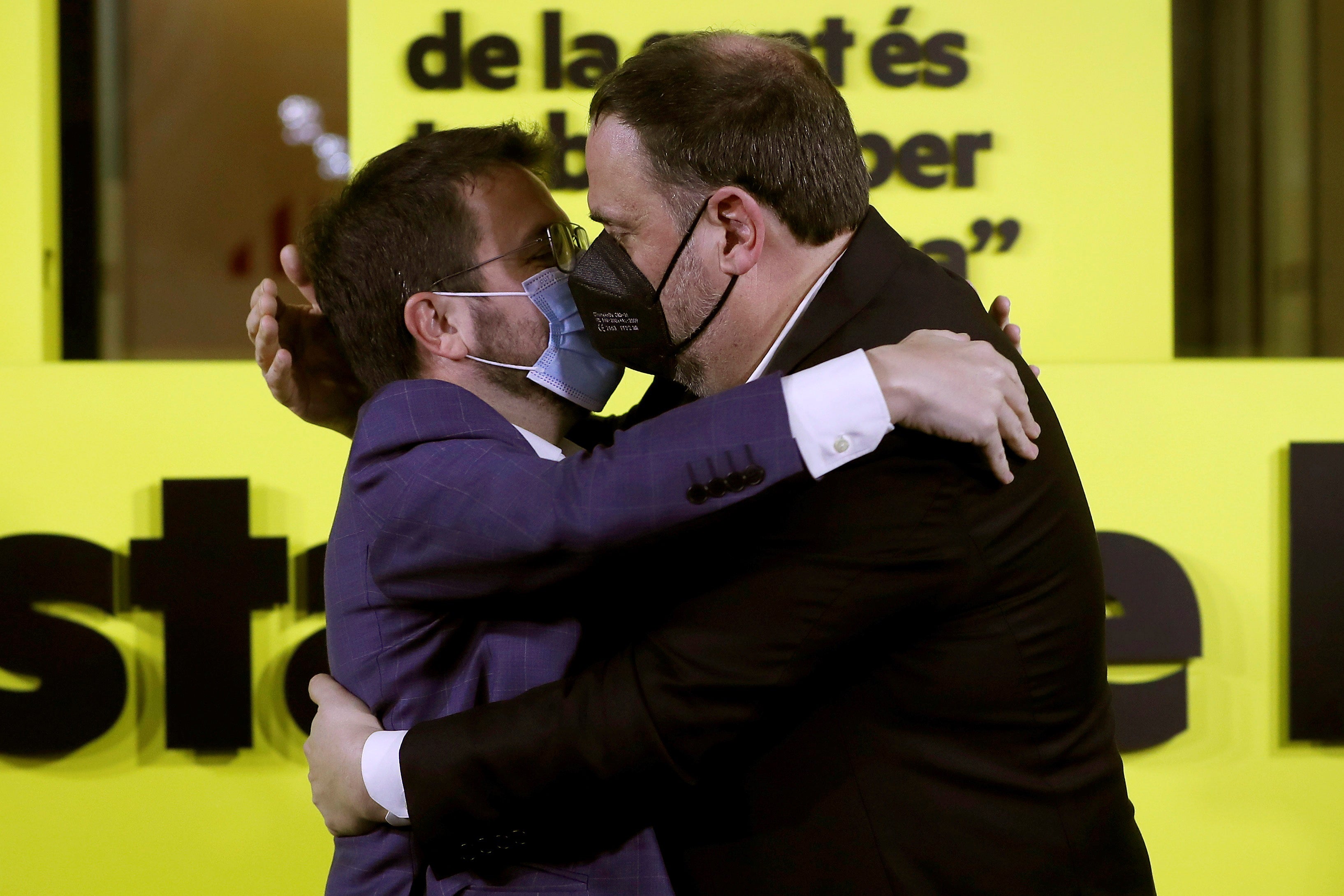 Pere Aragonés (left), the acting Catalan president and ERC party leader, embraces his vice president Oriol Junqueras at a press conference in Barcelona on Sunday