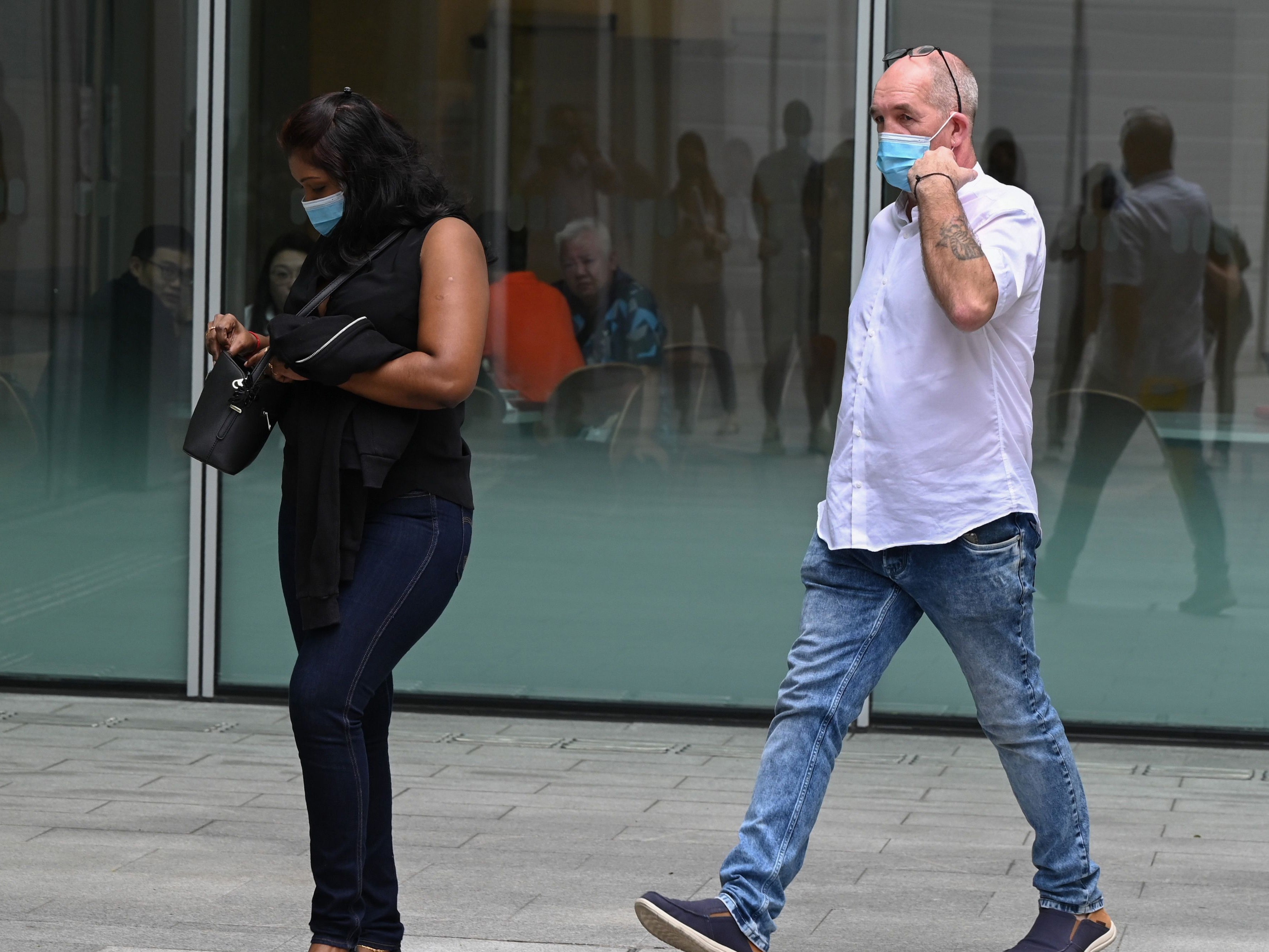 Nigel Skea and his wife Agatha Maghesh Eyamalai arrive at the State Court in Singapore on February 15, 2021