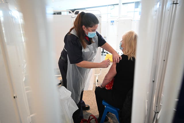 A vaccinator administers an injection of AstraZeneca/Oxford Covid-19 vaccine to a patient at the vaccination centre set up at Chester Racecourse, in Chester, northwest England, on 15 February, 2021. An epidemiologist has cautioned that we cannot get too comfortable amid the coronavirus vaccine rollout.