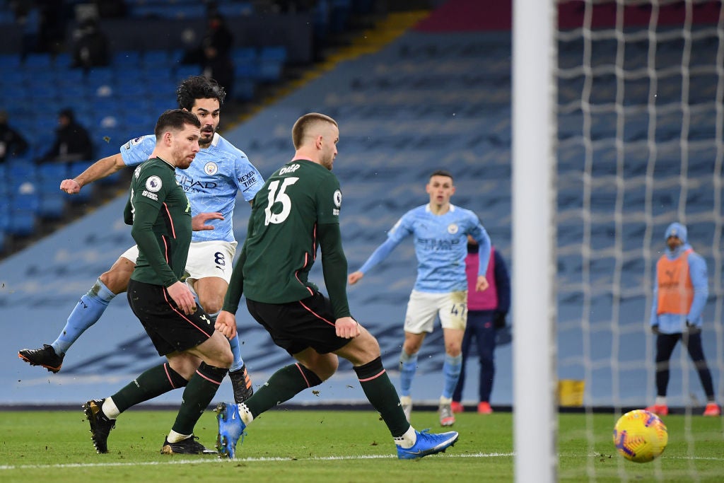 Ilkay Gundogan scores while under pressure from Pierre-Emile Hojbjerg and Eric Dier