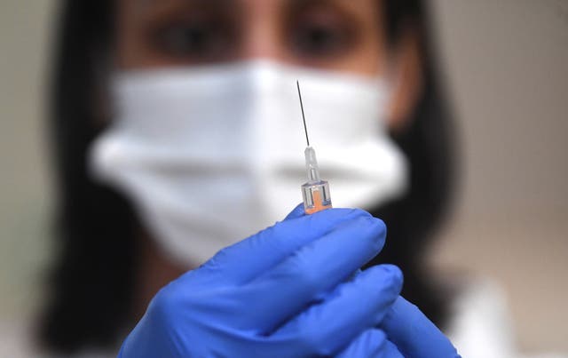 A medic prepares the AstraZeneca Covid19 vaccine at an NHS vaccination centre in Ealing, west London