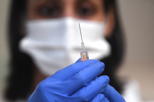 A medic prepares the AstraZeneca Covid19 vaccine at an NHS vaccination centre in Ealing, west London