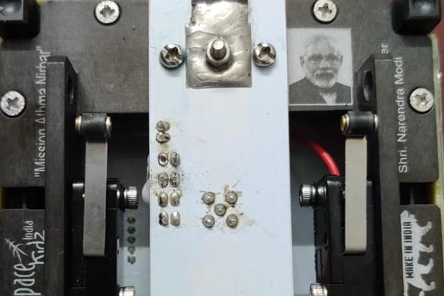 <p>An image of the SD SAT with Indian Prime Minister Narendra Modi’s photograph on it</p>