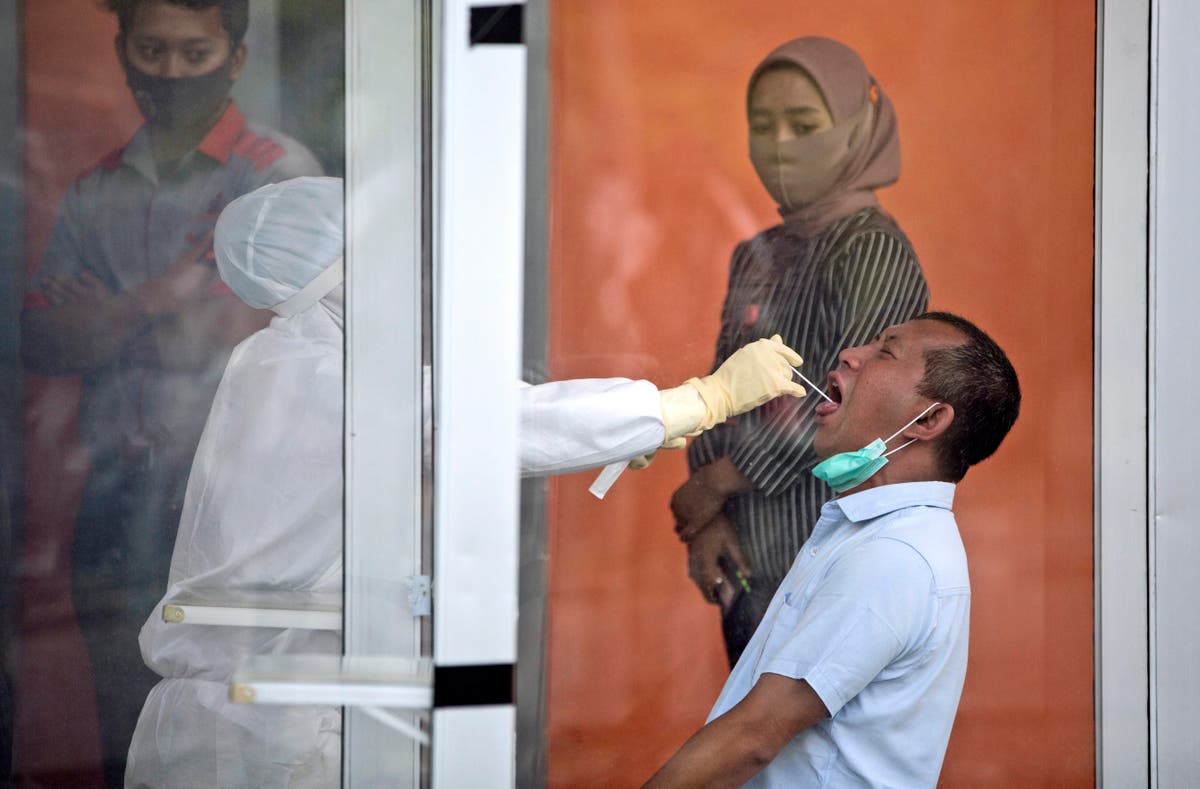 Indonesian public workers, traders next in line for shots