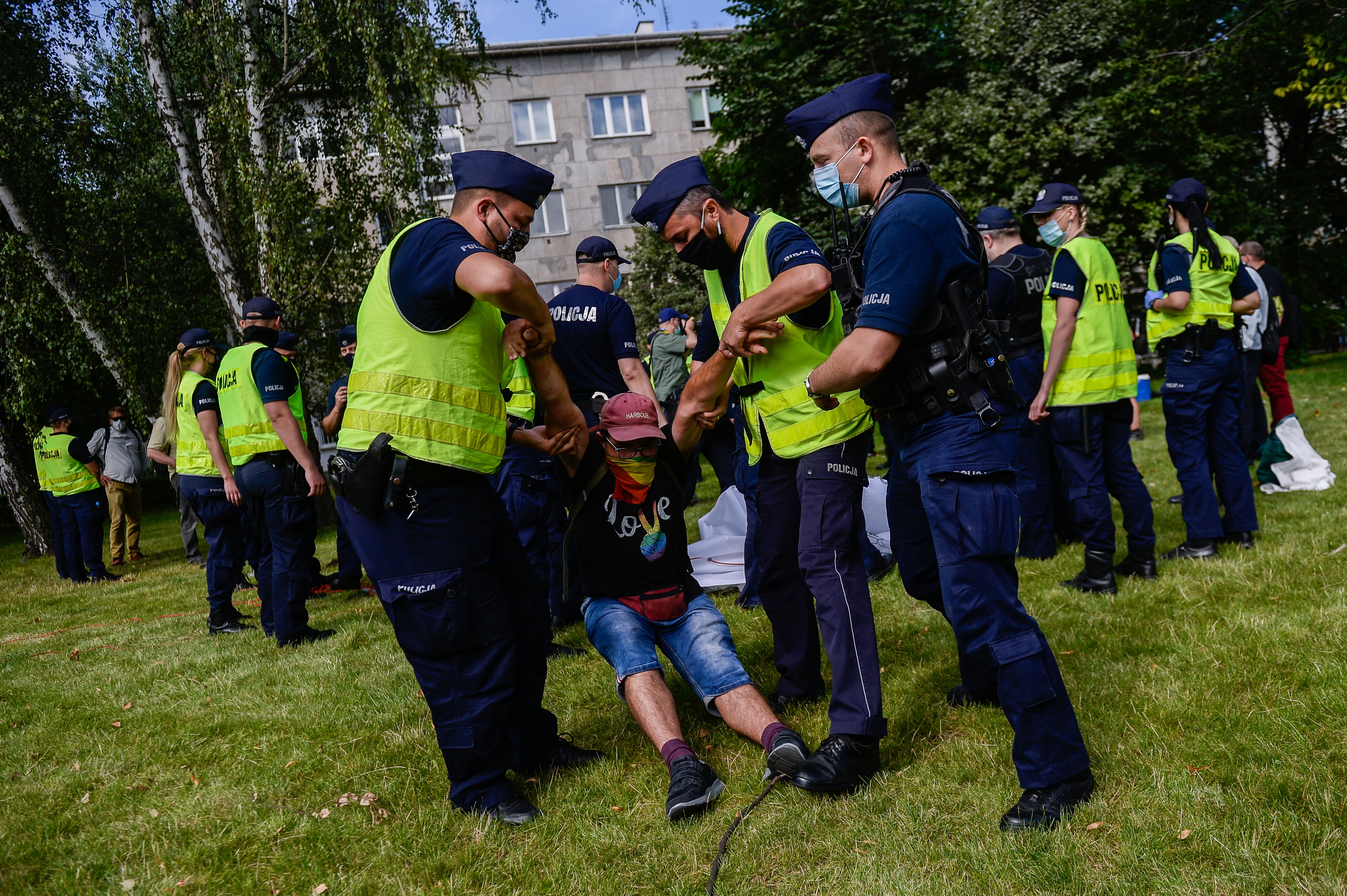 Police remove a protester wearing a shirt saying ‘love’ with rainbow colours as he protests against the president, Andrzej Duda. Growing hostility towards the LGBT+ community in Poland has driven a wave of demonstrations