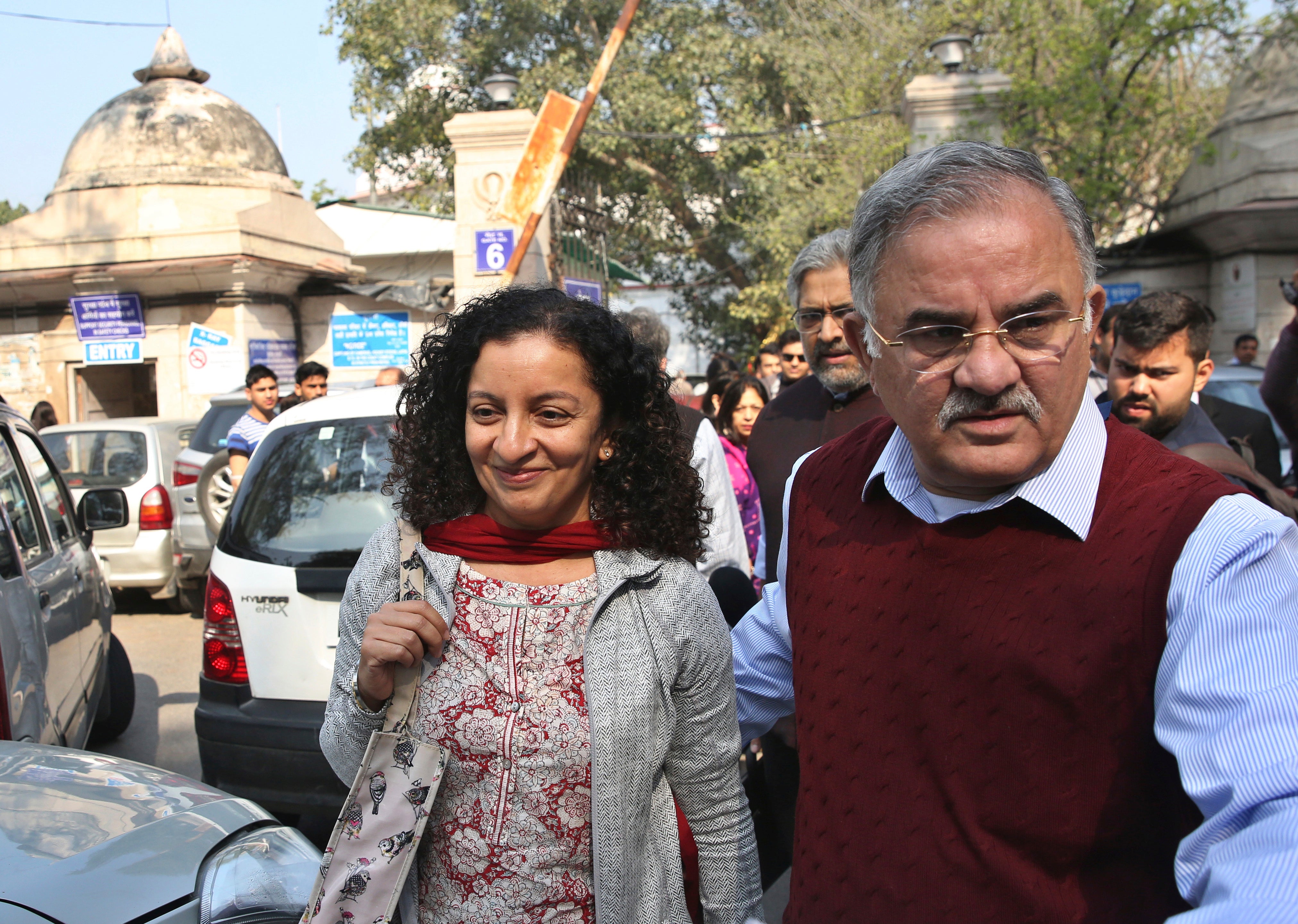 Indian journalist Priya Ramani smiles as she leaves Patiala House Court in New Delhi