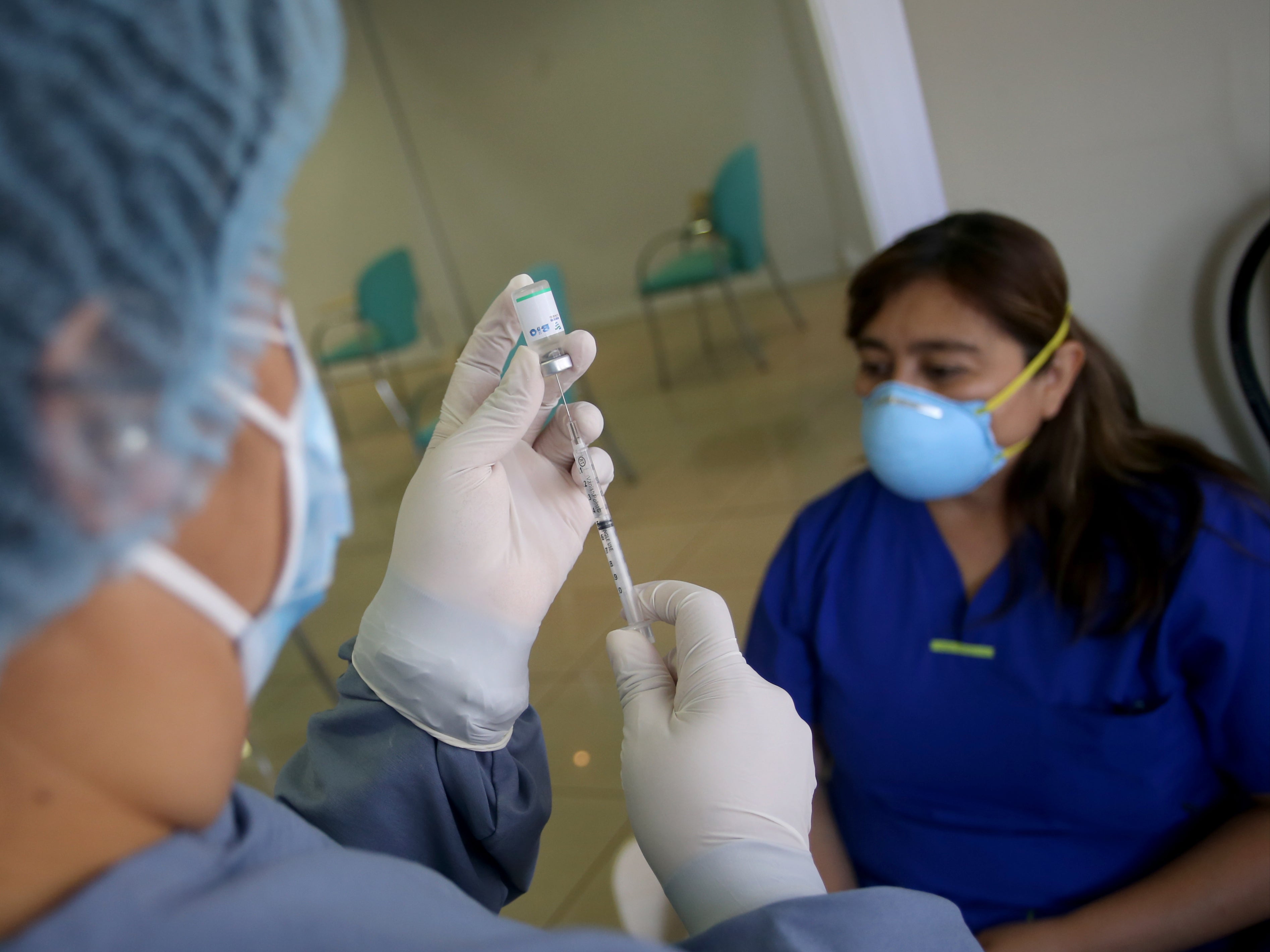 A doctor prepares a dose of China’s Sinopharm vaccine during a priority Covid-19 vaccination of health workers at Ricardo Palma clinic on 15 February, 2021 in Lima, Peru