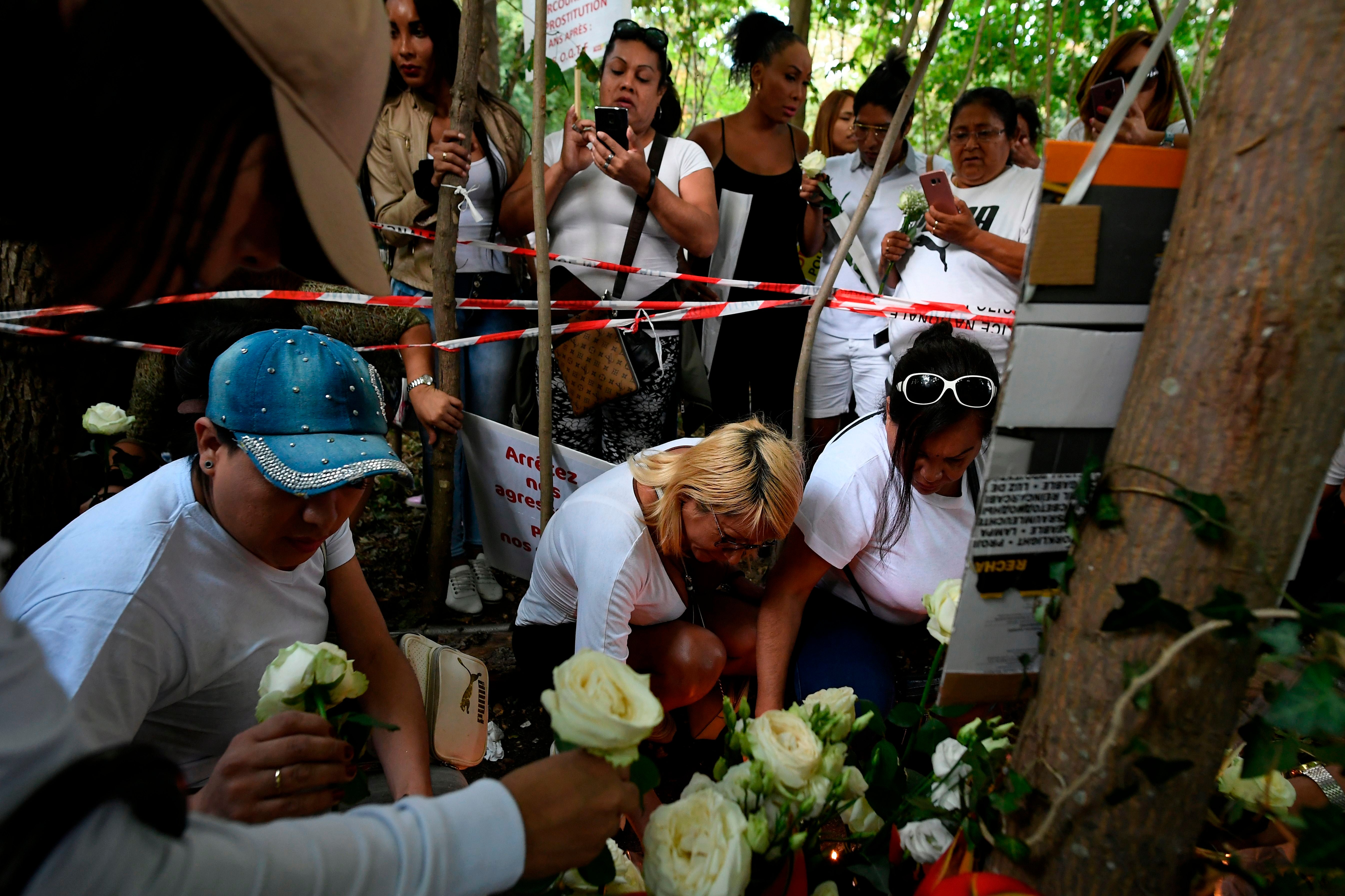 People lay white roses at a makeshift memorial in tribute to Vanesa Campos, a 36 year-old transsexual sex worker who was killed the week before, at the Bois de Boulogne in Paris, in 2018