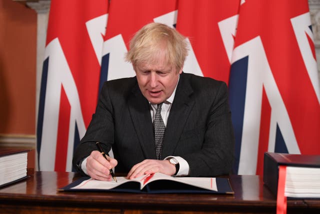 <p>The prime minister signs the Brexit trade deal with the EU in No 10 on 30 December 2020</p>