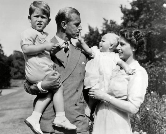 <p>Queen Elizabeth II and the Duke of Edinburgh holding Prince Charles and Princess Anne, 1952</p>
