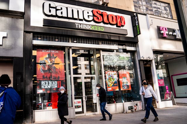 <p>Pedestrians pass a GameStop store on Thursday, Jan. 28, 2021</p>