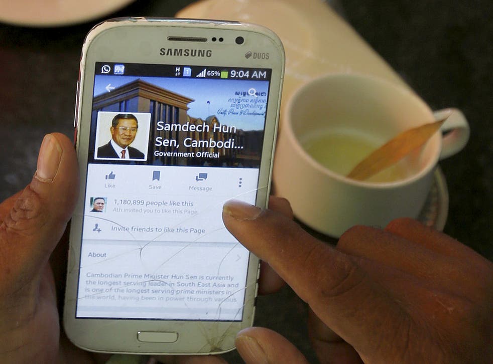 A person uses a smartphone to look at the Facebook page of Cambodia’s prime minister Hun Sen
