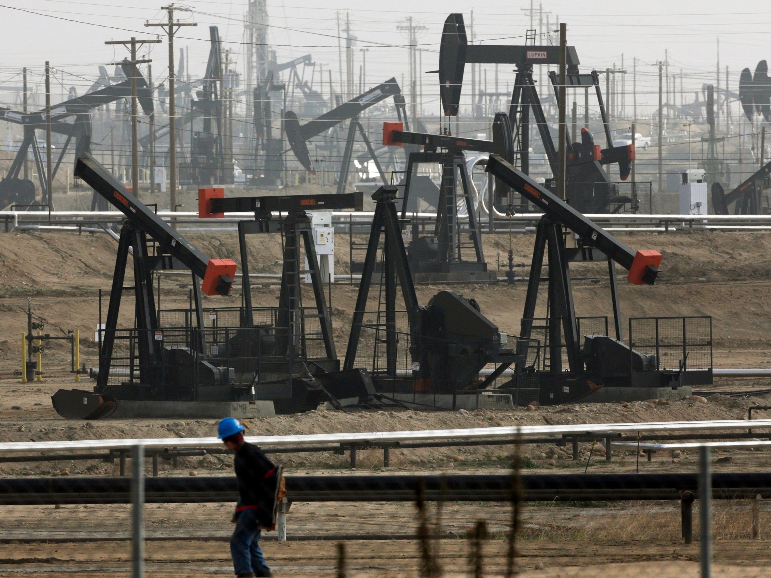 Pumpjacks are seen operating in Bakersfield, California in a fracking operation in 2016
