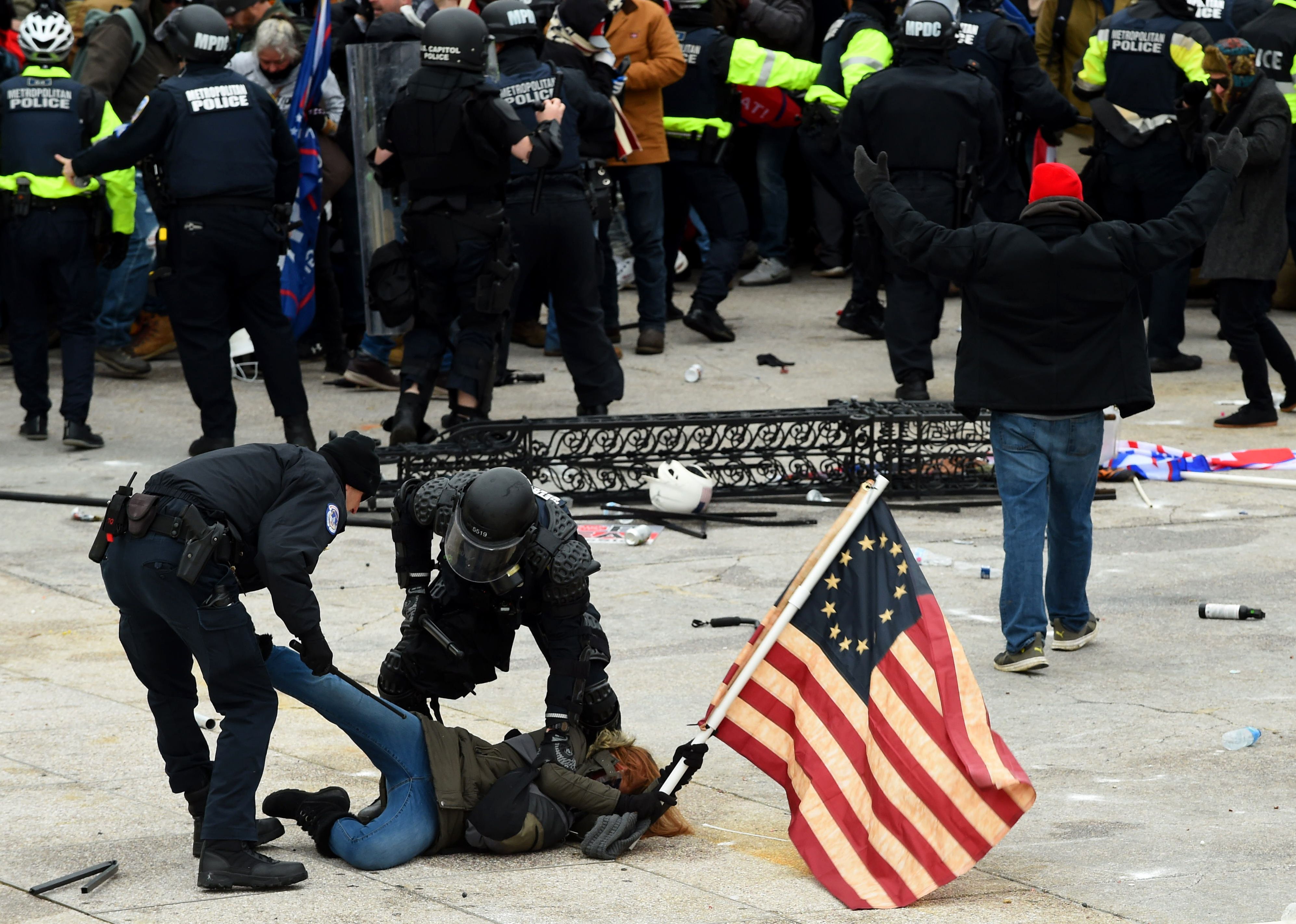 File image: Police detain a person as Trump supporters riot outside the Capitol on 6 January