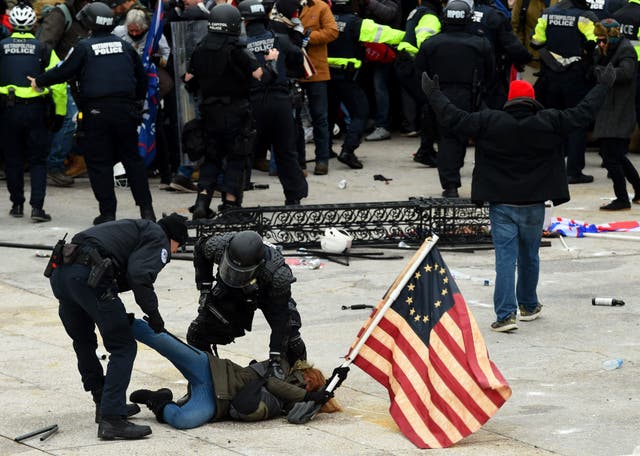<p>File image: Police detain a person as Trump supporters riot outside the Capitol on 6 January</p>