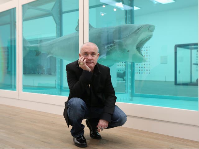 Hirst with his  artwork, titled The Physical Impossibility of Death in the Mind of Someone Living