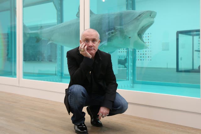 Hirst with his  artwork, titled The Physical Impossibility of Death in the Mind of Someone Living