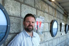 Journalist fined for Covid breach after photographing protest outside army barracks housing asylum seekers