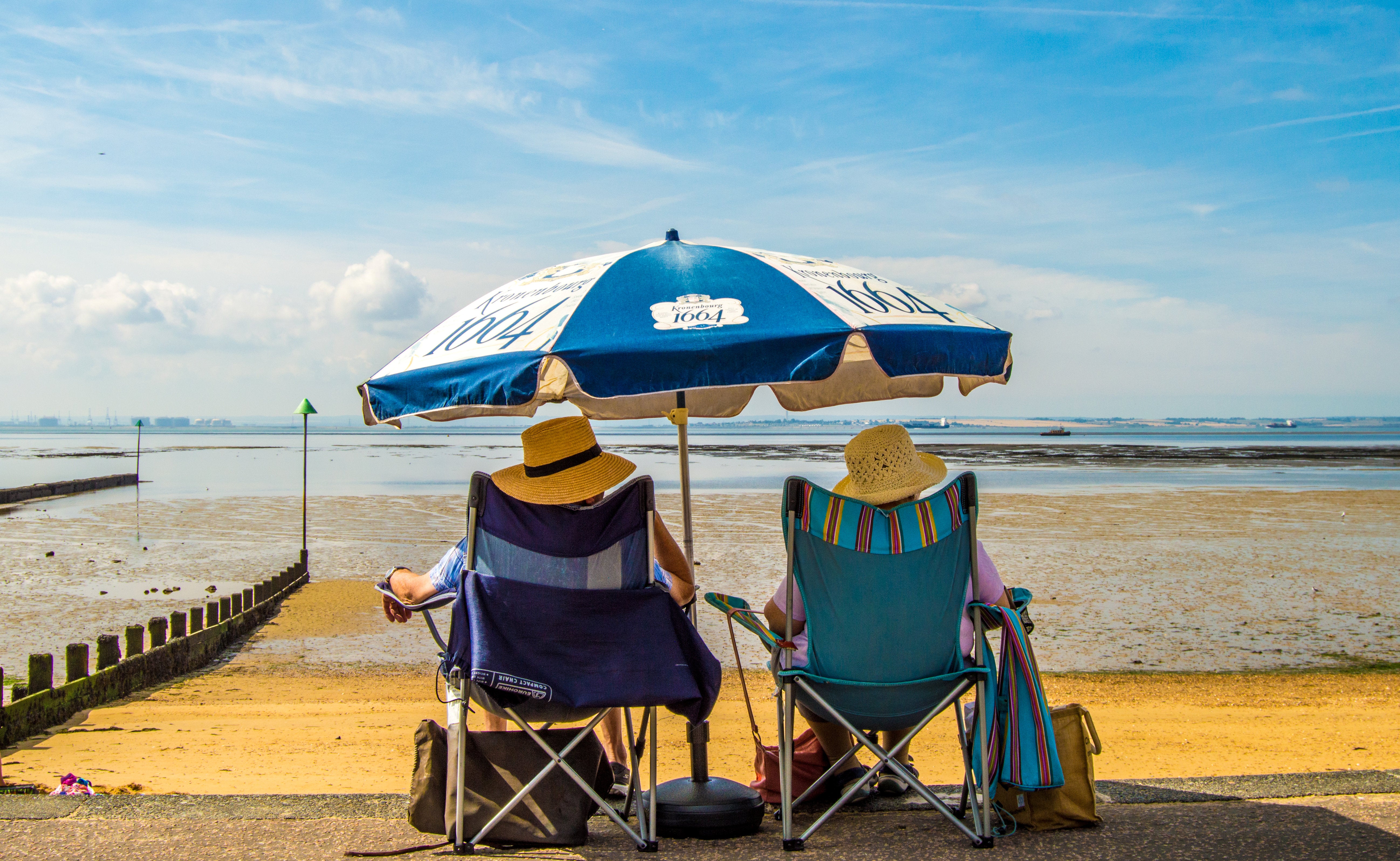 'On The Decks' - A old couple watch the world go by on a beach