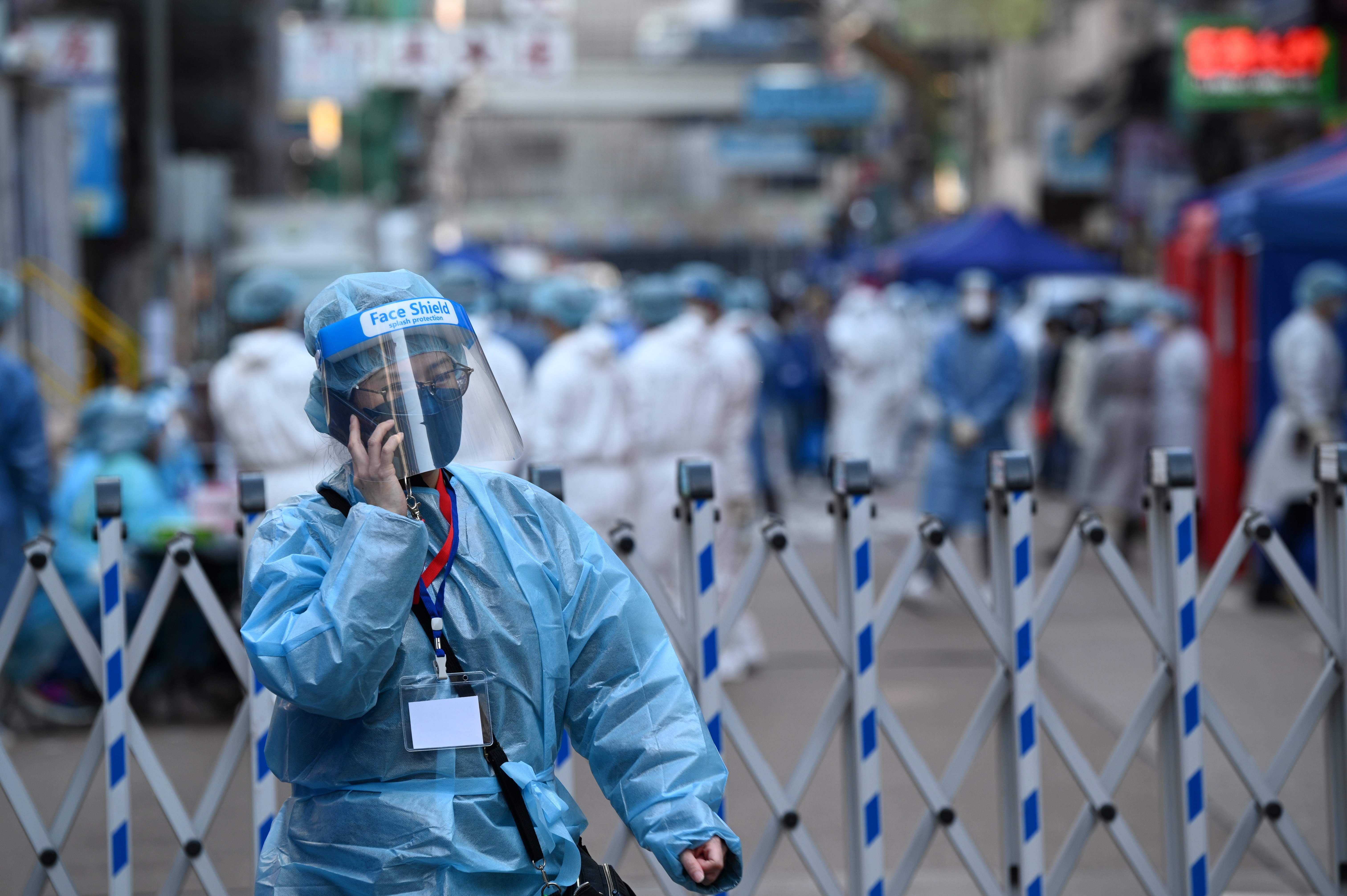 A health worker uses her phone in Hong Kong