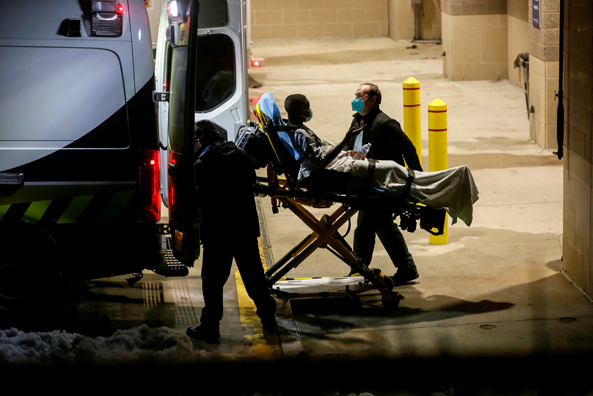 A patient at St. David's South Austin Medical Center is prepared for transport in Austin, Texas, on Wednesday, Feb. 17, 2021. Earlier in the day, hospital officials said some patients at the facility would be moved over to other hospitals in the area after the building began losing heat due to low water pressure. (Bronte Wittpenn/Austin American-Statesman via AP)