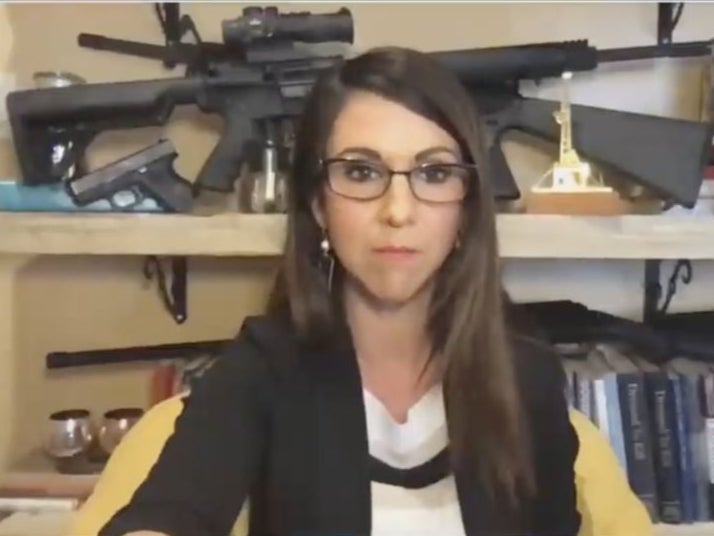 Rep. Lauren Boebert displays her guns during a Zoom meeting with the House Natural Resources Committee