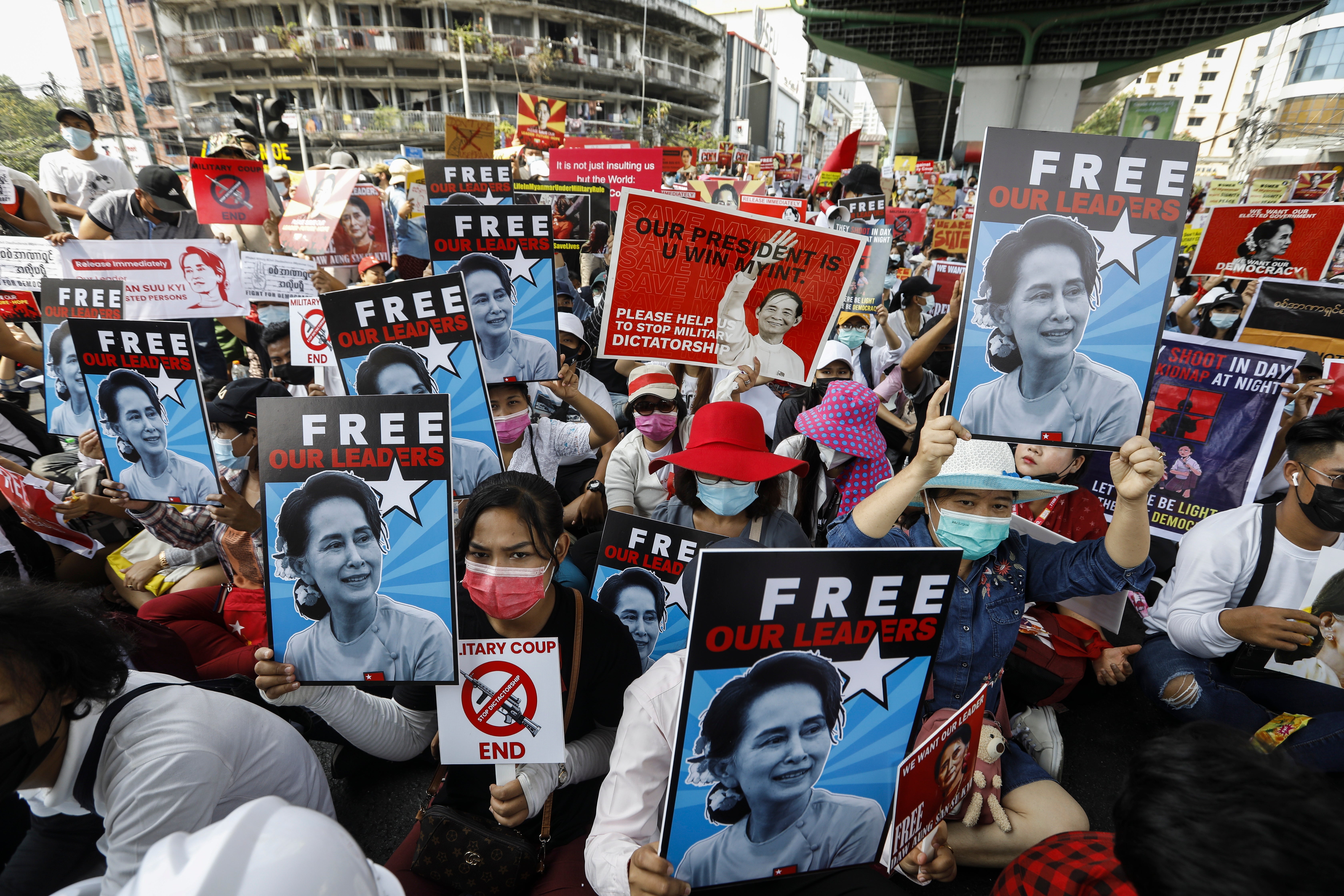 Protesters hold placards calling for the release of detained Myanmar State Counselor Aung San Suu Kyi during a protest against the military coup in Yangon, Myanmar, 19 February 2021