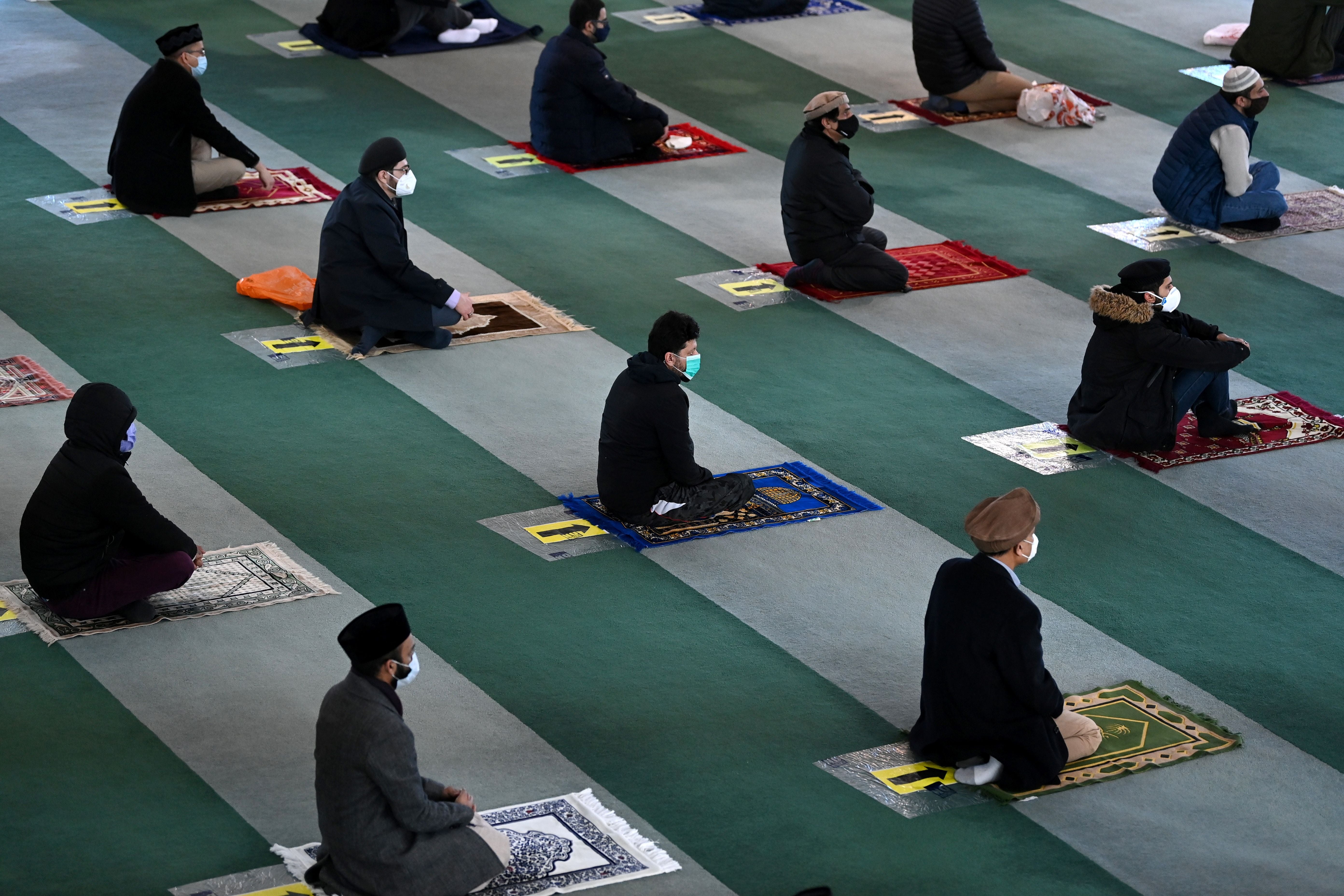 Muslim men take part in socially distanced Friday prayers