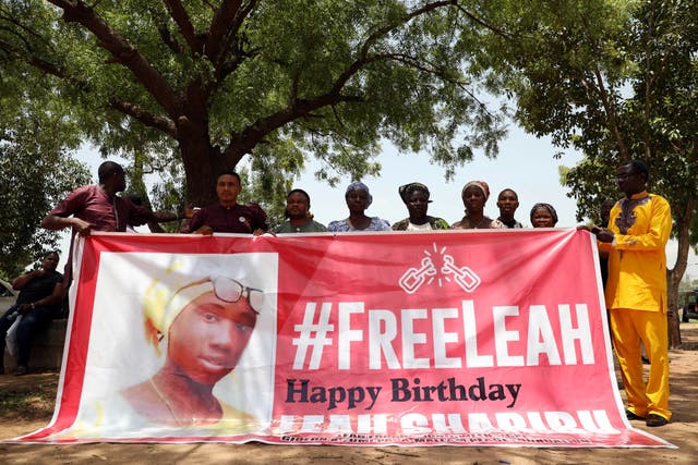 <p>Leah Sharibu’s family members hold banner to demand she is released at event to mark her 16th birthday in Abuja in Nigeria in 2019</p>