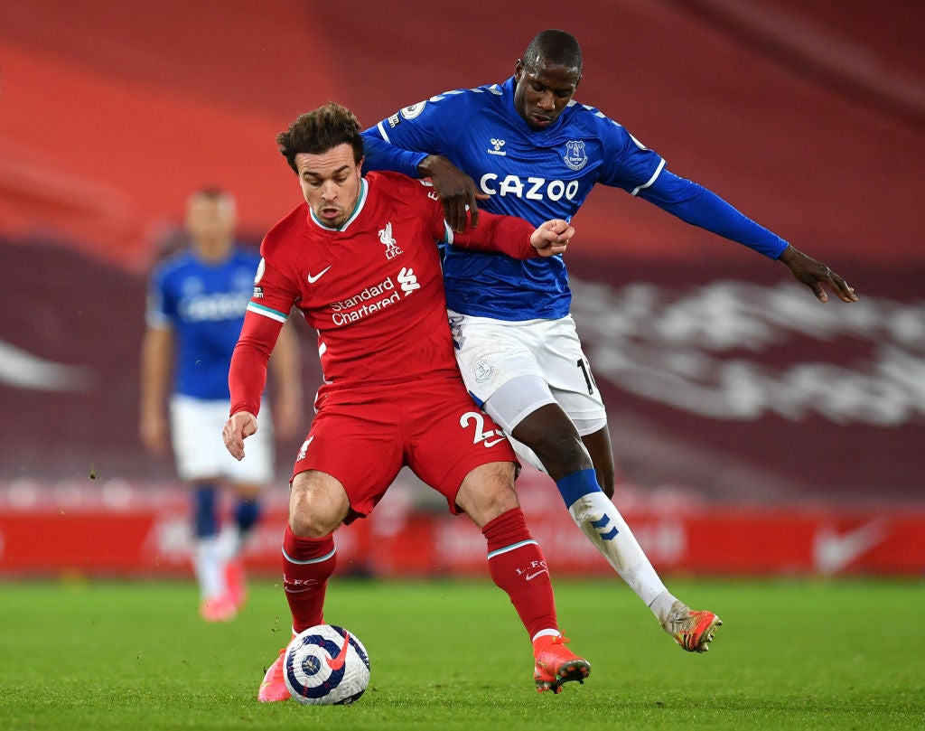 Xherdan Shaqiri is challenged by Abdoulaye Doucoure