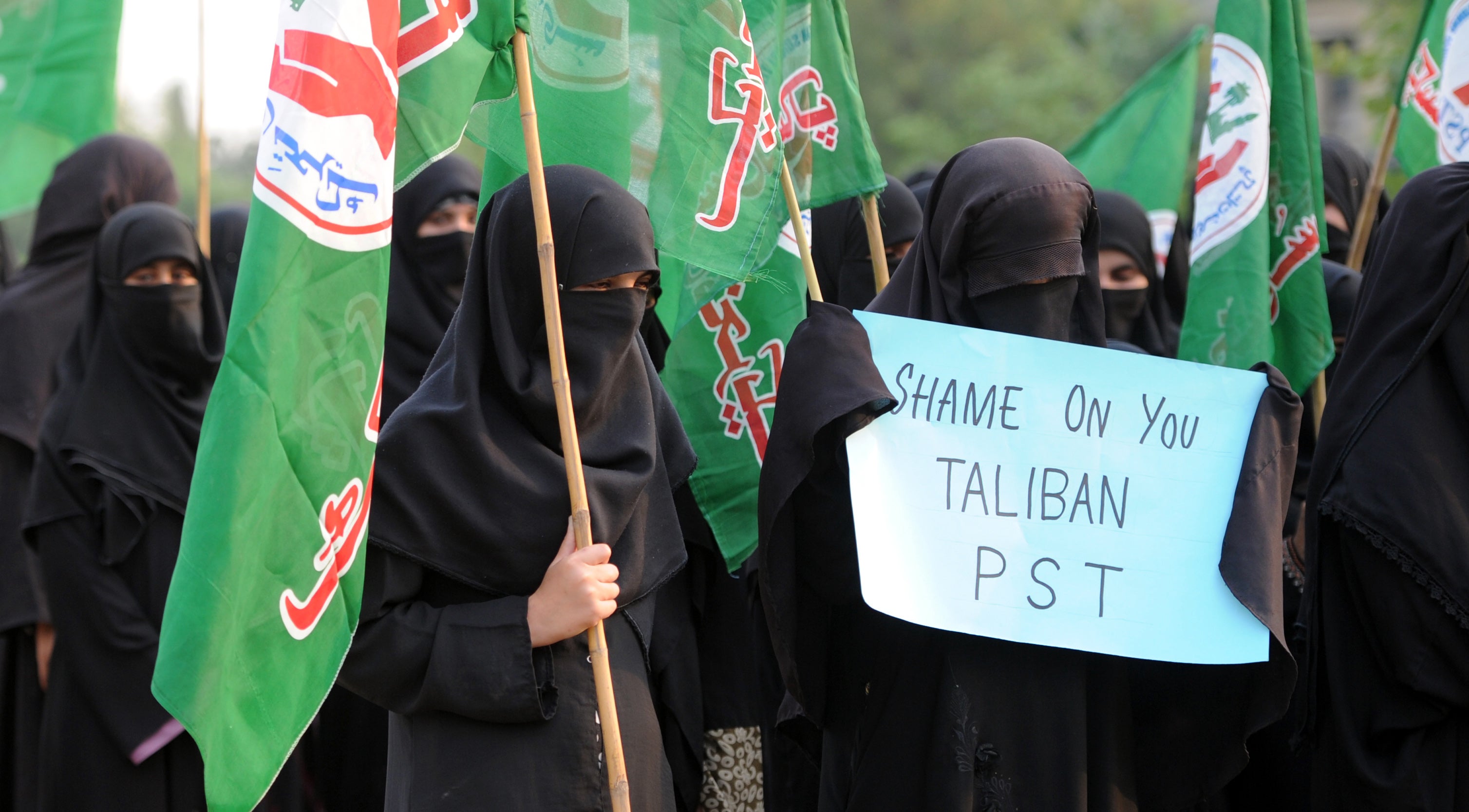 File image: A Pakistani veiled activist of an Islamic Sunni Tehreek party carries a placard during a protest against the assassination attempt by Taliban on activist Malala Yousafzai, in Islamabad on October 14, 2012