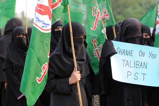 <p>File image: A Pakistani veiled activist of an Islamic Sunni Tehreek party carries a placard during a protest against the assassination attempt by Taliban on activist Malala Yousafzai, in Islamabad on October 14, 2012</p>