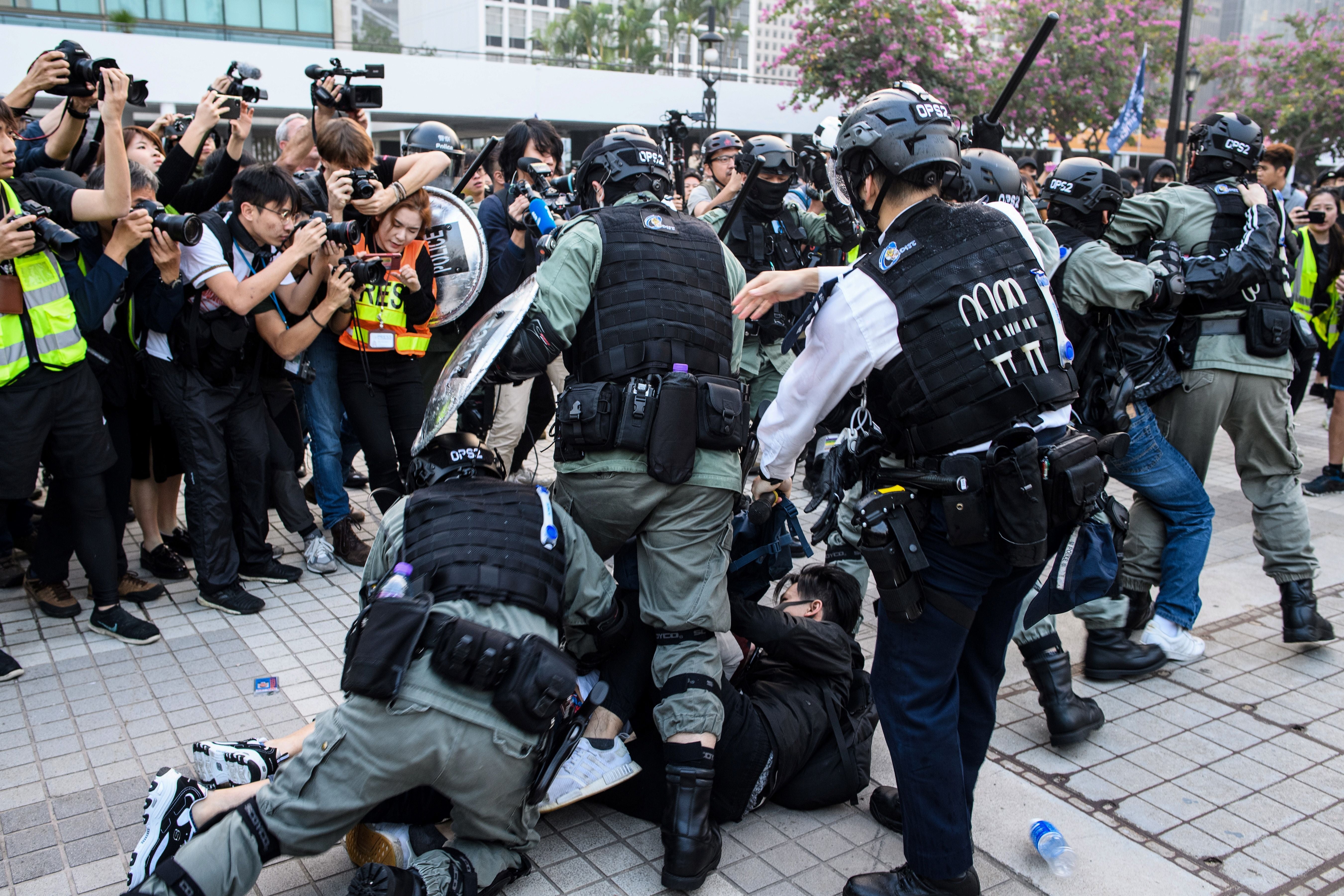 Police detain a man during a rally in Hong Kong on 22 December 2019 to show support for the Uighur minority in China.