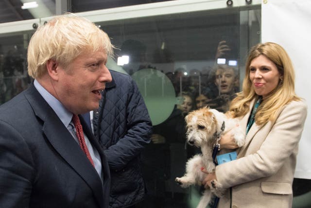 <p>Boris Johnson with partner Carrie Symonds and dog Dilyn at the count in Johnson’s Uxbridge constituency during the 2019 general election</p>